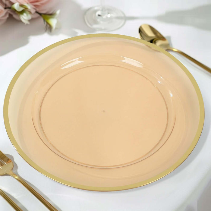 Elegant gold-rimmed peach plate on a table setting.