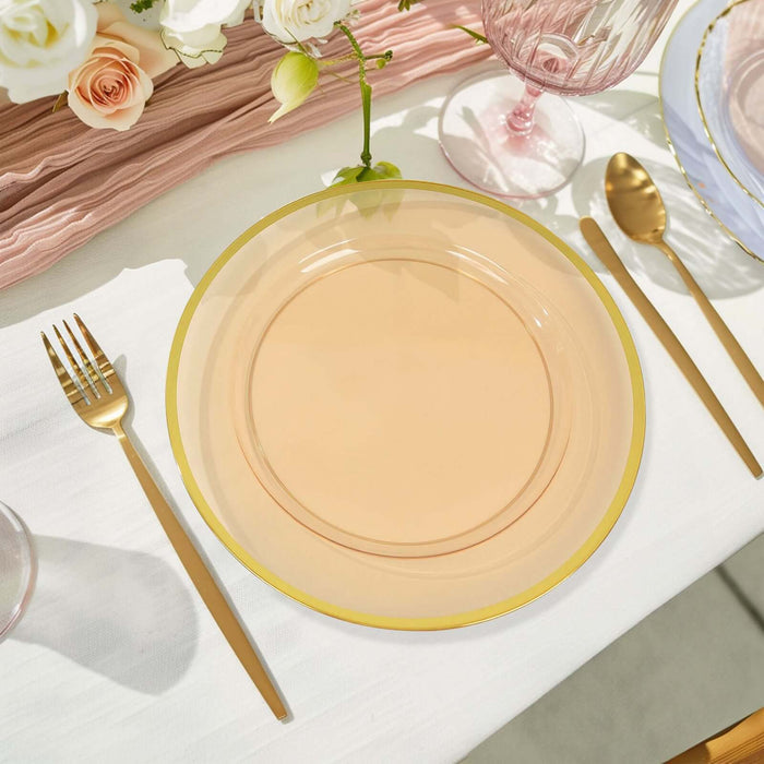 Elegant peach plate with gold rim on a stylish dining table setting.
