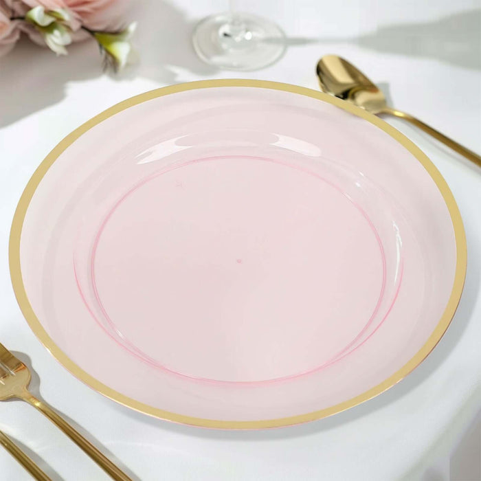 Pink plate with gold rim on a table setting