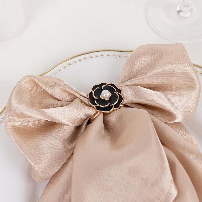 Elegant beige satin napkin bow with black flower and pearl accent.