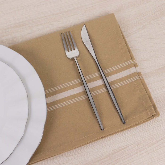 Dining set with plate, fork, and knife on a beige napkin.