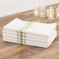 Stack of white kitchen towels with green stripes on a wooden table.