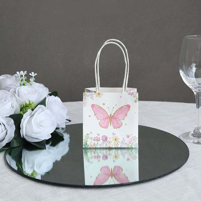 Decorative gift bag with butterfly design on a mirrored surface.