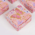 Pink butterfly thank you gift box with gold accents and colorful floral designs.