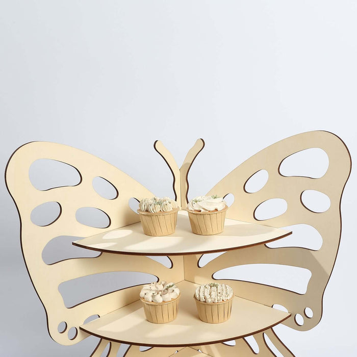 Butterfly-shaped cupcake stand with four cupcakes on display.