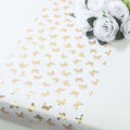 Gold butterfly patterned table runner on a white background.