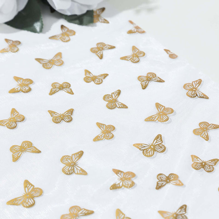 Gold butterfly embellishments on sheer white fabric.