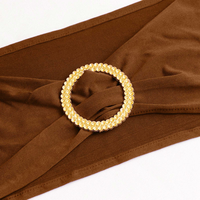 Brown fabric with a gold rhinestone circle embellishment. #whtbkgd