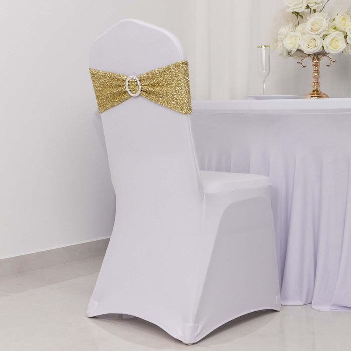 White chair cover with gold sequin bow for elegant event decor.