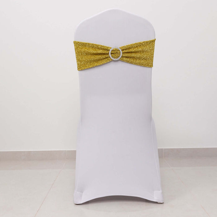 White chair with a gold glitter sash and decorative buckle.