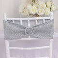 Silver glitter chair sash with rhinestone buckle on a white chiavari chair.