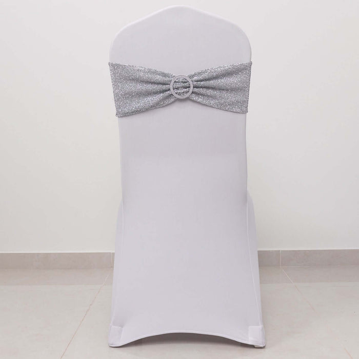 White chair cover with silver sparkly sash and decorative buckle