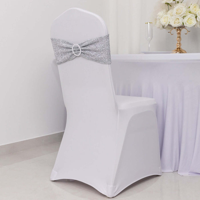 Elegant white chair cover with silver sequin bow, perfect for events.