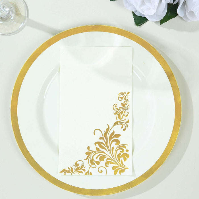 Elegant white napkin with gold floral design on a gold-rimmed plate.