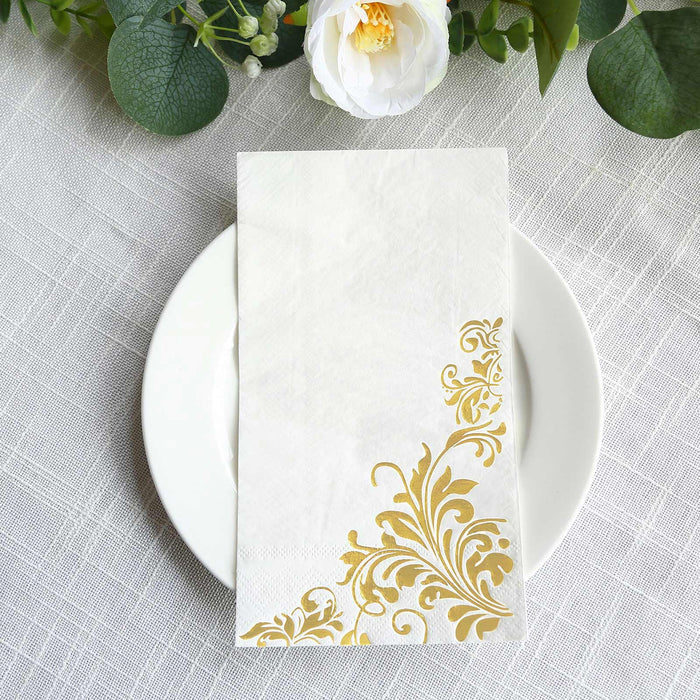 Elegant gold floral napkin on a white plate, styled for a sophisticated table setting.