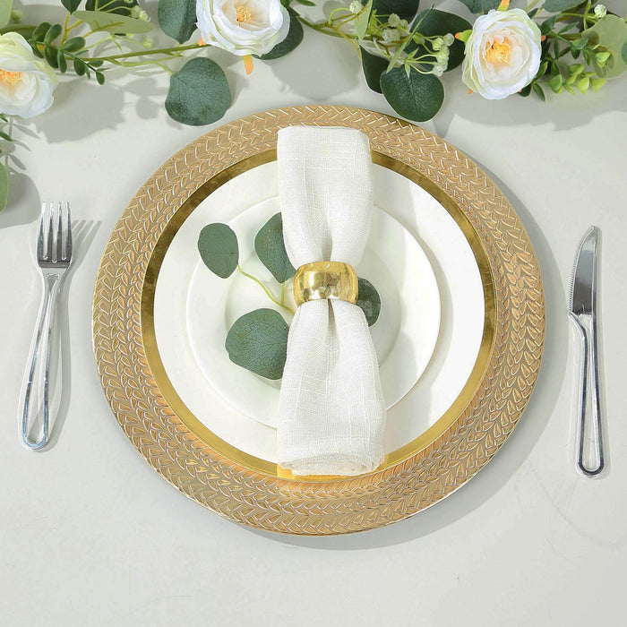 Elegant dining table setting with gold charger plate and white napkin.