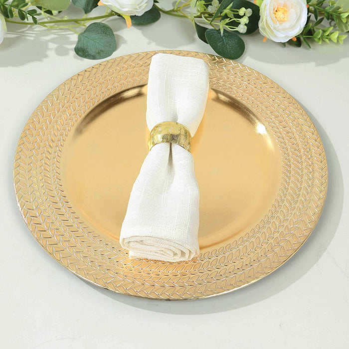 Gold decorative plate with a white napkin and ring, styled for dining.