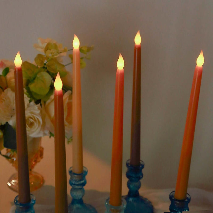 Colorful decorative candles in blue holders with a soft glow.