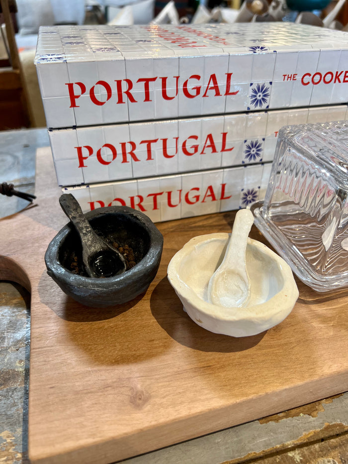 Handmade salt and pepper set: one dark pepper bowl and one cream salt bowl with spoon rests