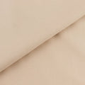 Beige textured fabric showcasing a smooth and ribbed surface.