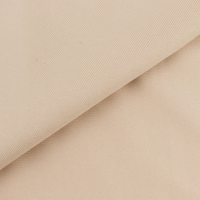 Beige textured fabric showcasing a smooth and ribbed surface.