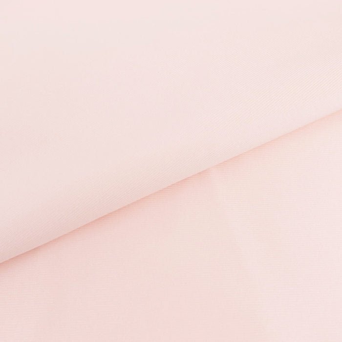 Light pink fabric with a smooth texture and folded edges.