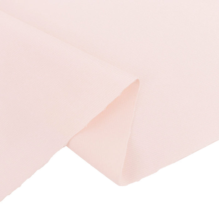 Light pink fabric swatch with a textured finish