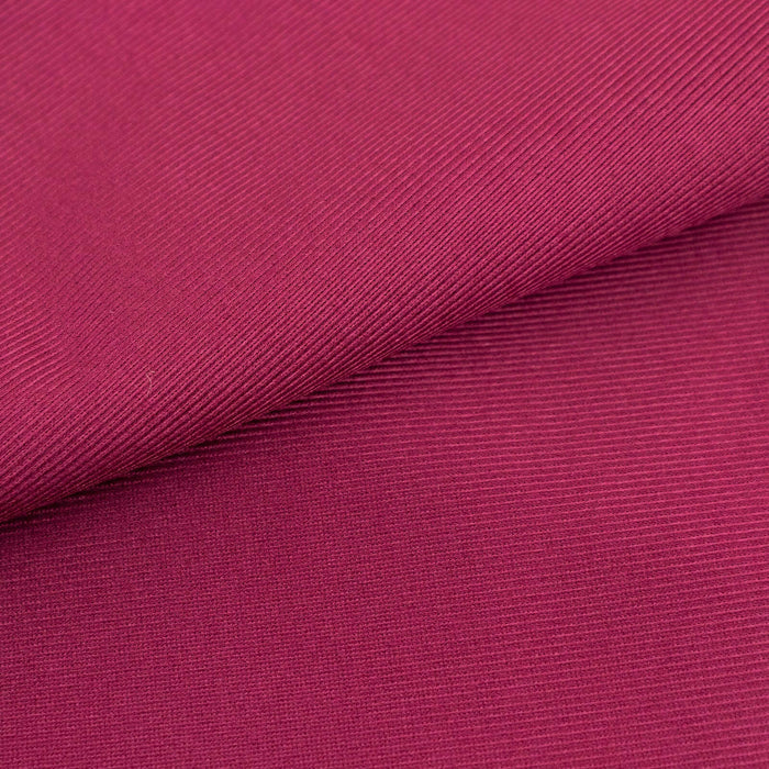 Textured magenta fabric showcasing fine ribbing details.