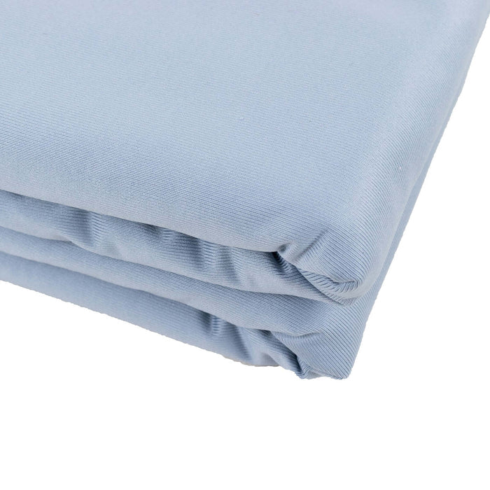 Light blue folded fabric on a plain background