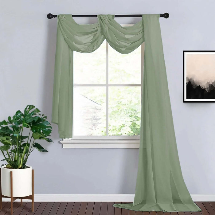 Sheer green curtains draped elegantly over a window with a potted plant.