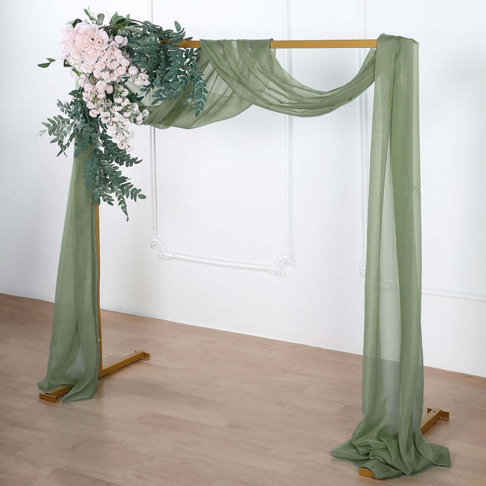 Green draped wedding arch with floral arrangement