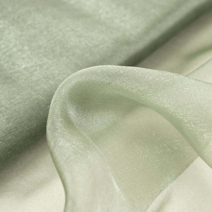 Sheer green fabric draped elegantly, showcasing its soft texture and flow.