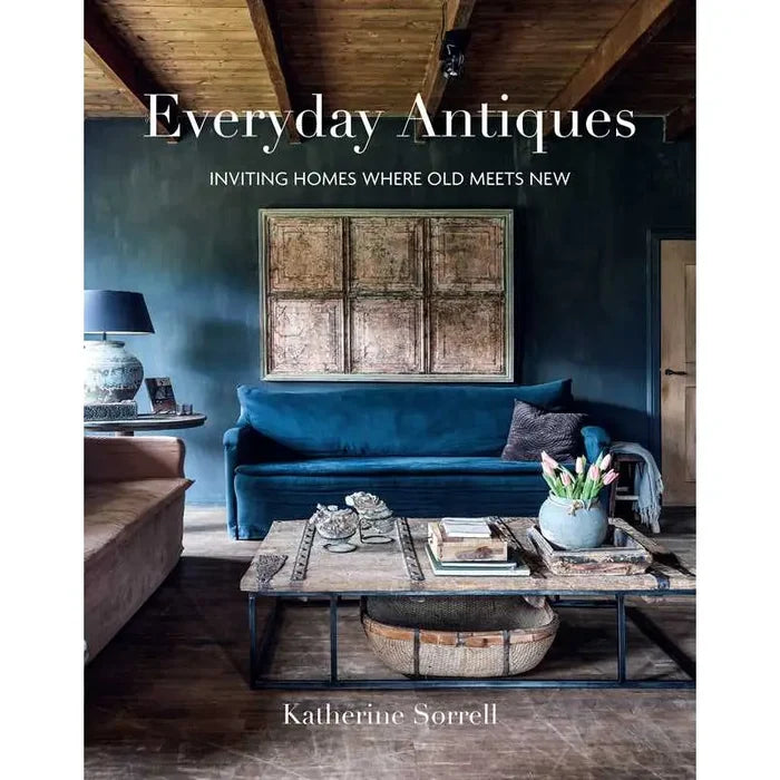 Antique home decor book cover with blue sofa and wall art