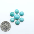 Hubei Cloud Mountain Turquoise cabochons, blue and green color with black matrix, polished stones on a white background with a US dime for scale