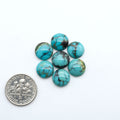 Hubei Cloud Mountain Turquoise cabochons, blue and green color with black matrix, polished stones on a white background, with a US dime for scale