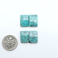 Hubei Cloud Mountain Turquoise cabochons, blue and green color with black matrix, polished stones on a white background with a US dime for scale