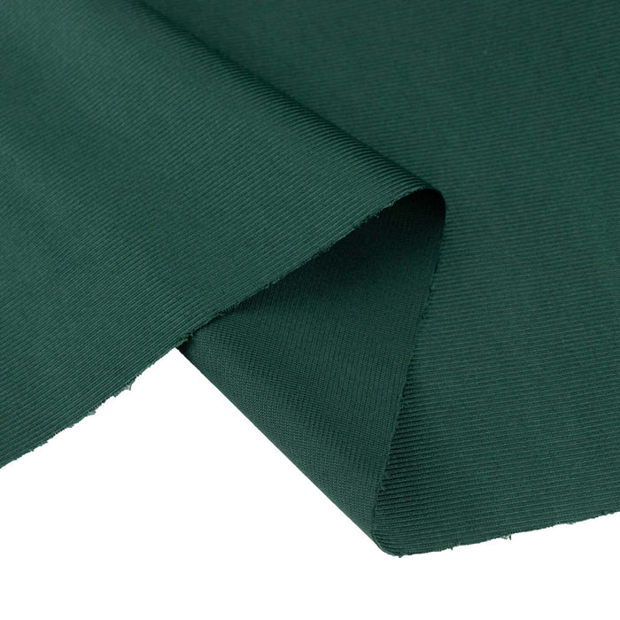 Green textured fabric with a folded edge.