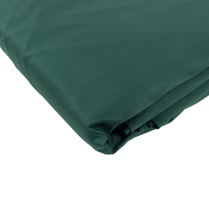 Green fabric roll on a plain background