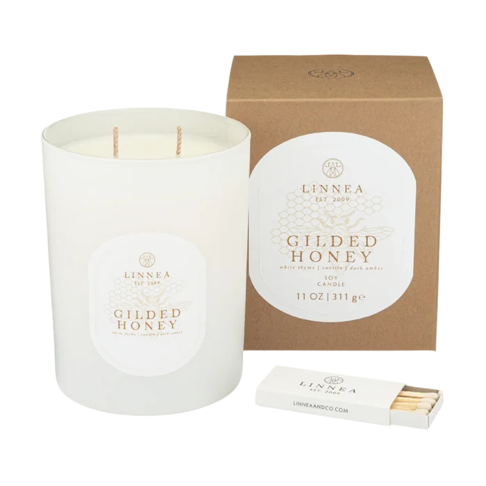 White scented candle with twin wicks, round label, kraft gift box, and matchbox