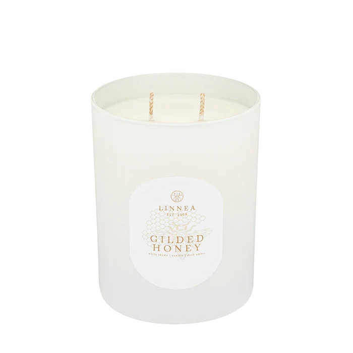 White scented candle with twin wicks and round label