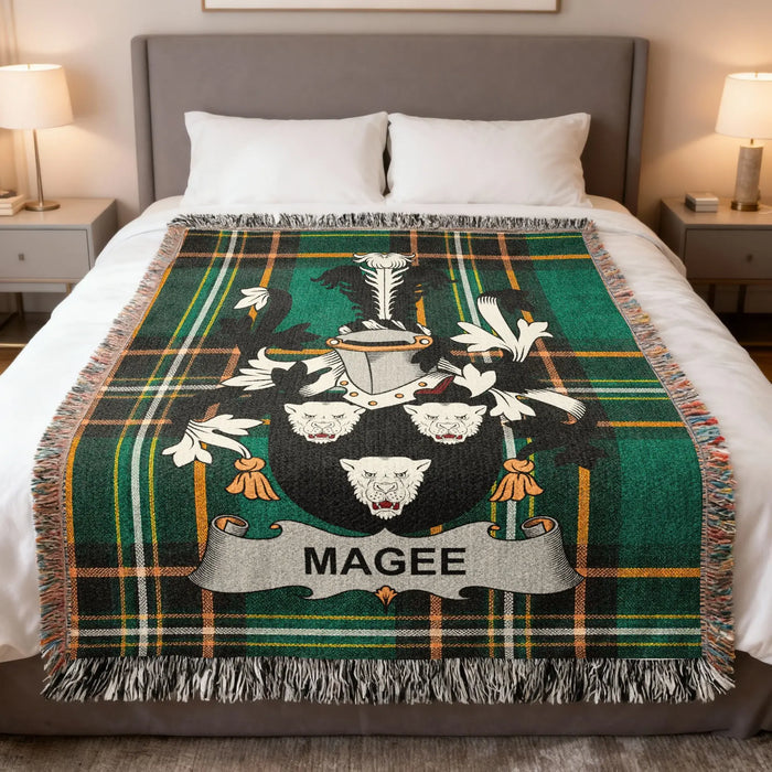 Magee family crest Irish National Tartan woven blanket displayed on a bed.
