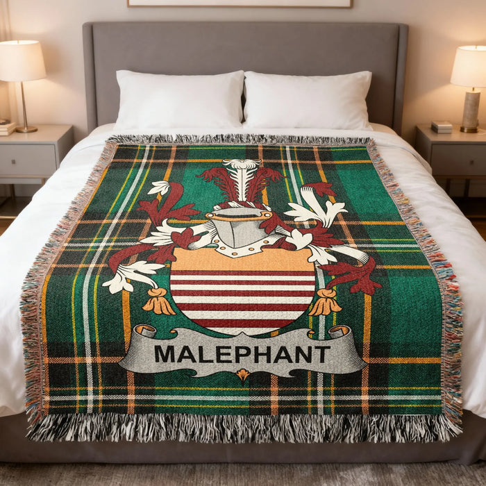 Plaid blanket with Malephant coat of arms centered on a bed.