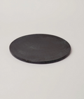 Round deep green marble serving platter with smooth surface and subtle dark veining