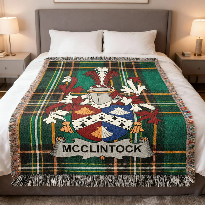 McClintock family crest Irish National Tartan woven blanket displayed on a bed.