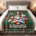 McClintock family crest Irish National Tartan woven blanket displayed on a bed.