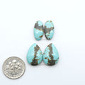 Number 8 Turquoise cabochons, blue and green color with brown matrix, polished stones on a white background, with a US dime for scale