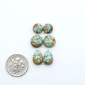Number 8 Turquoise cabochons, blue and green color with brown matrix, polished stones on a white background, with a US dime for scale