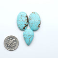 Three turquoise stones with a dime for scale on a white background Number 8 Turquoise Cabochons have been selected for their quality and unique appearance. Don't miss the chance to add a one-of-a-kind piece to your collection.