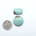 Number 8 Turquoise cabochons, blue and green color with brown matrix, polished stones on a white background, with a US dime for scale