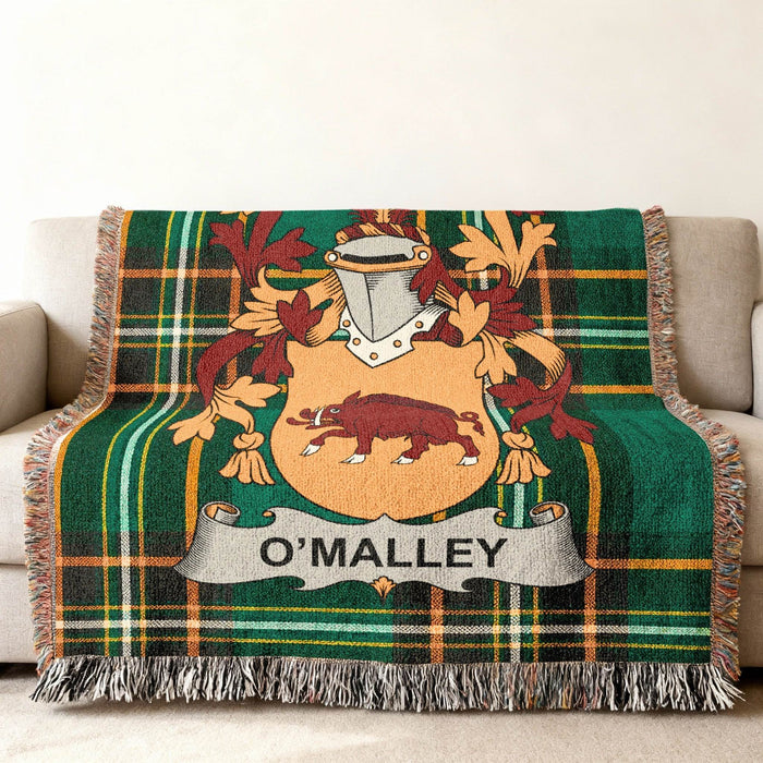 O'Malley family crest on a green tartan woven throw blanket.